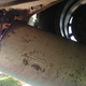 Muffler, hanging by a single bolt now.